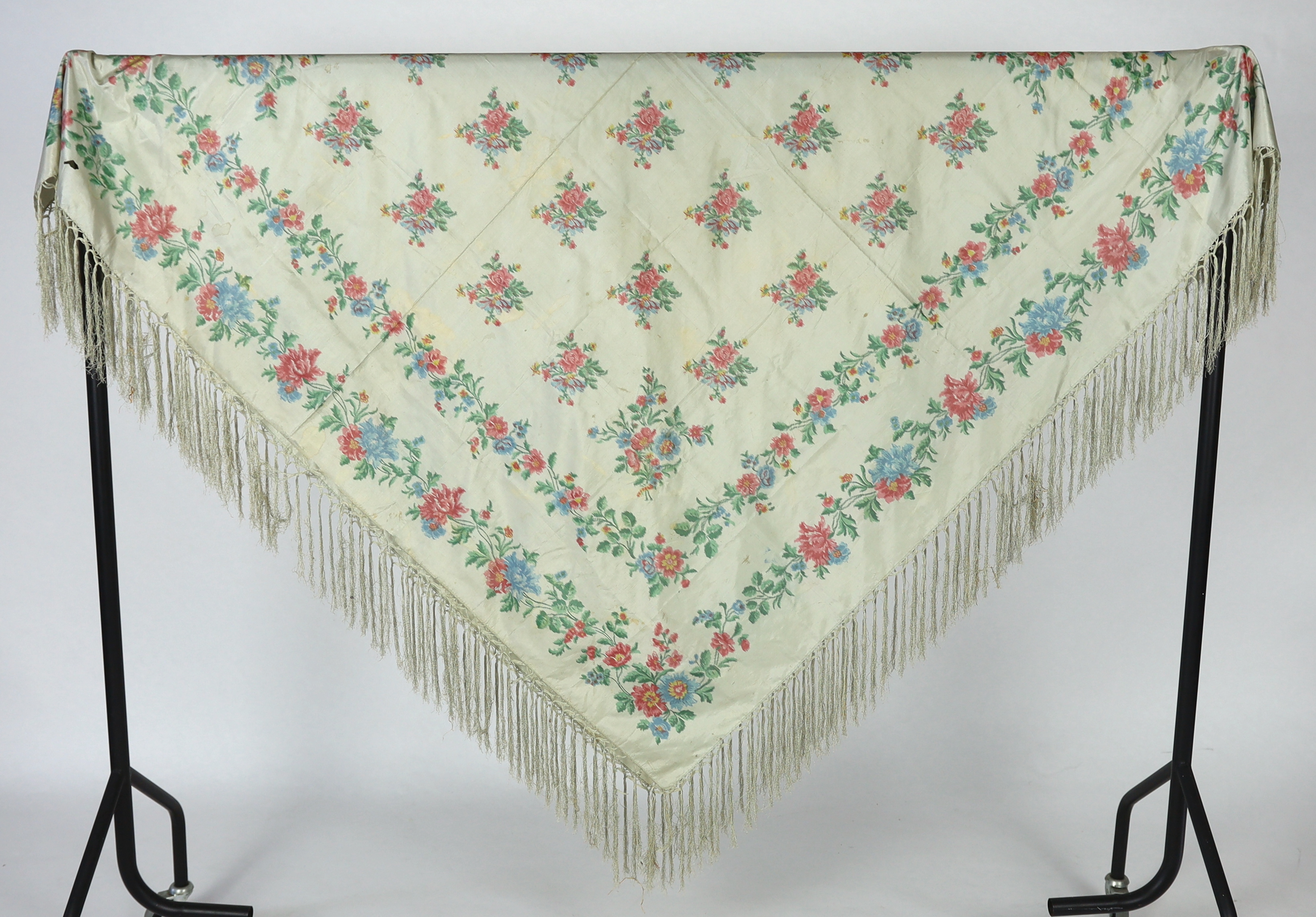 A French silk shawl, c.1800-1840, of a type modelled by Madame Recamier in the painting by François Gerard, printed on the warp thread into a rose pattern, with long fringing, 174 x 170cm